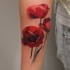 Tatuaje en el antebrazo,
amapolas delicadas rojas