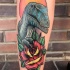 Dinosaur and rose tattoo on leg