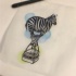 Funny zebra balloon with busket on blue-and-green background tattoo design