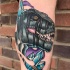 Great dinosaur head and crystals tattoo on leg