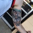 Great owl and compas tattoo on arm