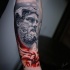 Hercules statue face tattoo on forearm