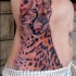 Tatuaje de guepardo impresionante en el costado