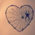 Little black spider sitting on heart-shaped net tattoo design