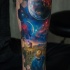 Little boy and space tattoo on forearm