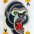 Lovely green-eyed screaming gorilla head tattoo design