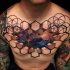 Meditating man tattoo on chest with 3d style hexagons