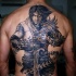 cavaliere mistico con spada e catene tatuaggio pieno di schiena