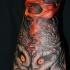 Owl with red skull wrist tattoo