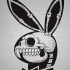 Playboy rabbit logo with skeleton inside tattoo design