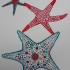 Posh red-and-blue printed starfish trio tattoo design