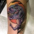 Purple dinosaur tattoo on leg