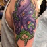 Purple octopus tattoo on shoulder