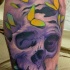 Purple skull and yellow moths tattoo on leg