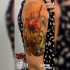Tatuaggio realistico con fiori di papavero sull'avambraccio