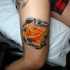 Realistic rose tattoo on arm