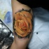 Realistic yellow rose tattoo on biceps