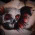 Skull and clock tattoo on chest