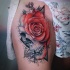 Skull and rose tattoo on thight