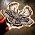 Traditional black-and-white moth with elk horns tattoo design