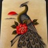 Traditional peacock sitting on branch with roses tattoo design