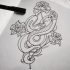 Uncolored reptile curled around flowers tattoo design