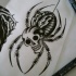 Unusual black-and-white spider with skull head tattoo design