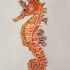 Wonderful orange seahorse with white dots tattoo design