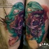 Abstract style colored biceps tattoo of human skull stylized with mystic eye