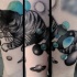 Abstract style colored cat with planets tattoo