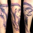Abstract style colored forearm tattoo of interesting ornaments