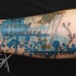 Abstract style colored forearm tattoo of lettering with airship