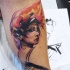 Abstract style colored leg tattoo of beautiful woman face