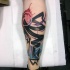 Abstract style colored leg tattoo of various ornaments