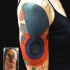 Abstract style colored shoulder tattoo of various figures