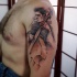 Abstract style colored shoulder tattoo of musician