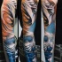 Abstract style colored sleeve tattoo of fantasy faces
