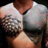 Abstract style large colored chest tattoo of various geometric figures