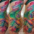 Abstract style multicolored side and thigh tattoo
