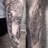 Accurate looking black ink forearm tattoo of angel woman with flowers and leaves