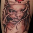Accurate looking colored shoulder tattoo of sexy nurse portrait