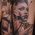 Accurate looking colored woman portrait tattoo on shoulder combined with flowers and night butterfly