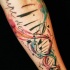 Tatuaje  de and multicolor en el antebrazo