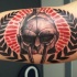 Amazing looking colored biceps tattoo of gladiators helmet with ornaments