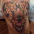 Tatuaje  de ovis amenazante en la pierna