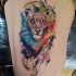 Erstaunlicher laufender Löwe Tattoo an der Seite von Javi Wolf mit farbigen Farbentropfen im Aquarell Stil
