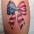 American flag tie a bow tattoo on leg for women