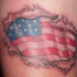 American flag under skin rip tattoo