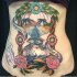 American traditional colored belly tattoo of sand clock stylized with eye, flowers and lettering