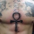 Ancient like black ink chest tattoo of Egypt symbol